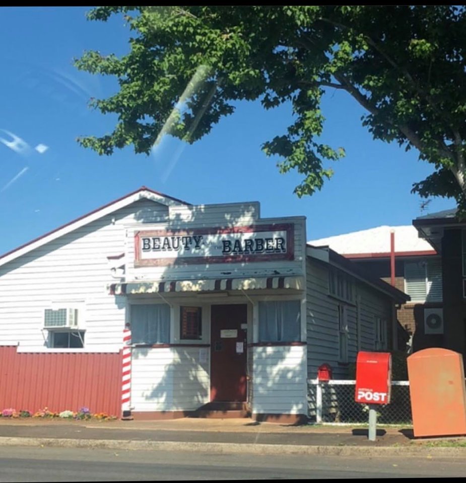 The white weatherboard shop on Holberton Street under a big shady tree